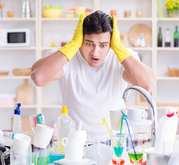 Man frustrated at having to wash dishes