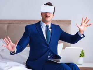 Businessman wearing a virtual reality headset in the bedroom