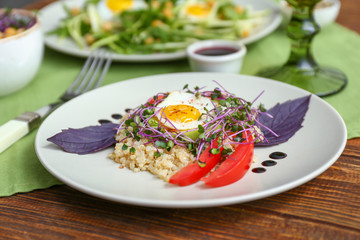 Plate with tasty salad on table