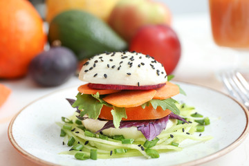 Plate with tasty salad on table