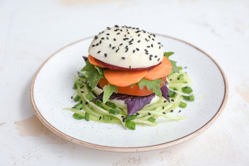 Plate with tasty salad on table