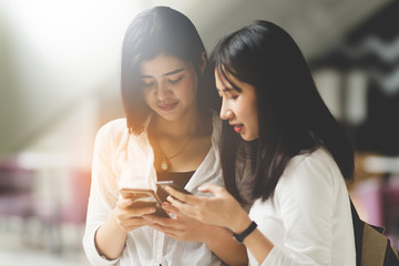 Asia women using smartphone working playing with fun and happy in free time.