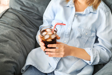Obraz na płótnie Canvas Woman drinking tasty cola at home