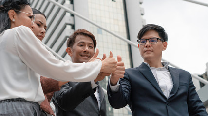 Fototapeta na wymiar group of asian business people thumb up together to show teamwork