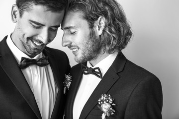 Black and white portrait of happy gay couple on their wedding day