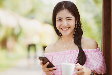 Asia woman using smartphone working playing with fun and happy in free time.