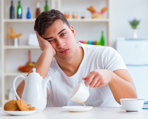 Man falling asleep during his breakfast after overtime work