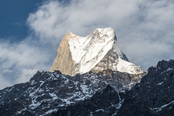 Obraz premium The upper summit of Machhapuchhre mountain (Mt.Fish tail) the holy mountains in Hindu religion believed it the rest place of God Shiva view from Dovan village, Nepal.