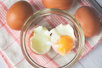 boiled egg on glass bowl and fresh eggs on the table background top view - Soft boiled eggs