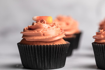 Chocolate halloween themed cupcakes, orange colored frosting, green and purple cupcake dough - 289956975