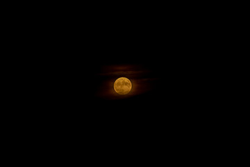Autumn harvest full moon with eerie cloud cover