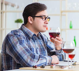 Professional sommelier tasting red wine