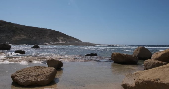 erosion prevention Gozo beach boulders near the salt flats pans of zebbug gozo malta in 10 bit 4K 60fps