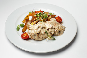 mushrooms in sauce with potatoes and a vegetables