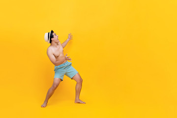 Fototapeta na wymiar enthusiastic shirtless asian man ready for summer with empty space beside him