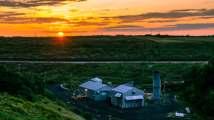 Biogas plant at sunset in urban area