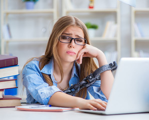 Young teenage female student preparing for exams at home