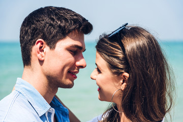 Romantic lovers young couple relaxing together on the tropical beach.Man hugging with woman and enjoy life.Summer vacations