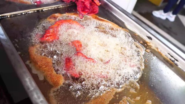 fried pork for tacos in oil in steel structure