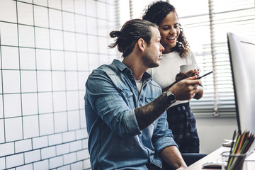Two business people working and discussing strategy with laptop computer.creative business people planning and brainstorm in modern work loft.Teamwork concept