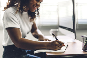 African american black woman working with laptop computer.creative business people planning and using pen in modern work loft