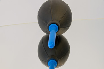 black bellows on mirrored surface