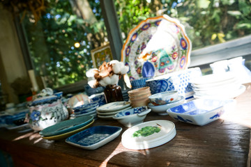 many old vintage thai ceramic table ware on table