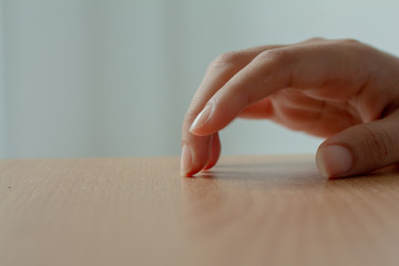 woman hand finger tapping on table.