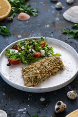 Fish breaded with fresh salad. The concept of a balanced lunch or dinner. Proper nutrition. Tasty and healthy dish.