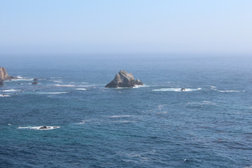 View of a small rock island in the Pacific Ocean close to Pacific Coast Highway, California, USA
