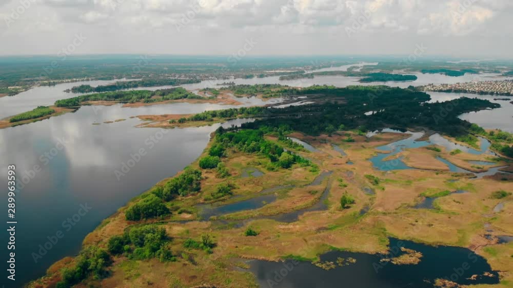 Poster drone flying above river with piece of land sky with clouds nature view