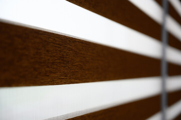 View down the side of a two fabric light filtering shade in open position 