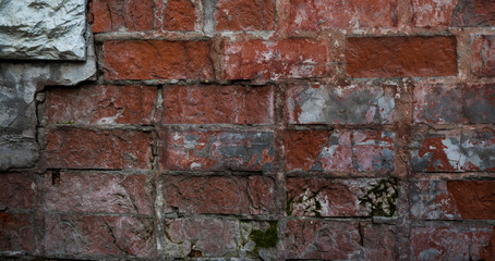 Texture of an old paint covered brick wall. Background image of an abandoned brick wall with painted over paint