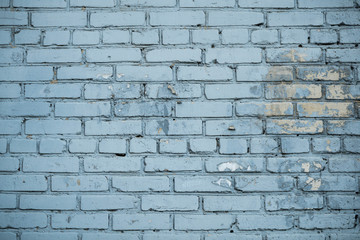 Fototapeta premium Texture of an old paint covered brick wall. Background image of an abandoned brick wall with painted over paint