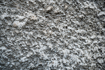 Texture of an old cracked concrete wall. Background image of a worn gray concrete surface