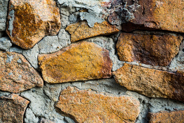 The texture of the old masonry. Background image of a stone-lined wall