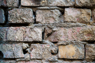 Texture of an old paint covered brick wall. Background image of an abandoned brick wall with painted over paint