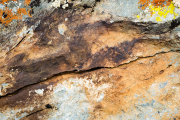 The texture of the stone overgrown with moss. Background image of a boulder