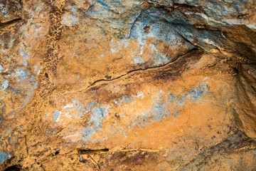 The texture of the stone overgrown with moss. Background image of a boulder
