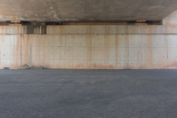 Fototapeta na wymiar Road bottom asphalt pavement and concrete wall space background