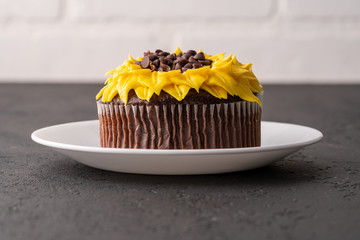 Beautiful sunflower decorated chocolate cupcake on black slate
