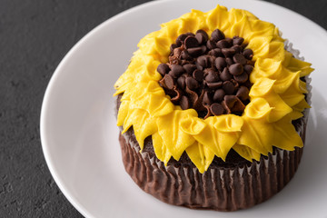 Beautiful sunflower decorated chocolate cupcake on black slate