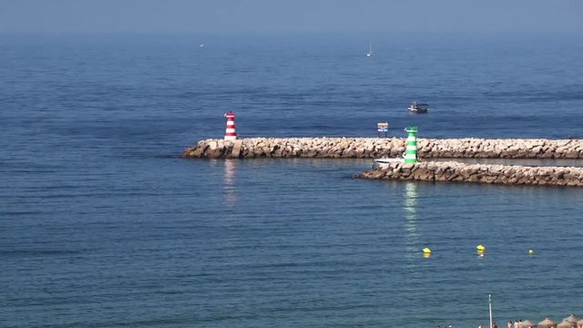 Villamoura harbour entrance  in the Agarve Portugal with boats and and light houses on a calm sunny morning