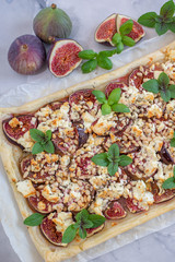 home made tart with figs and cheese on a table