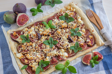 home made tart with figs and cheese on a table