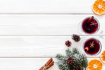 Background with mulled wine and New Year decoration on white wooden background top view frame copy space