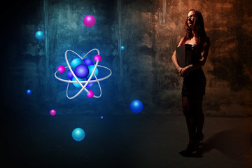 Sexy young secretary student or teacher presenting atom icon