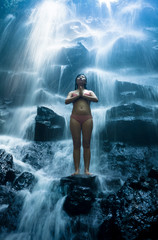 Obraz premium natural portrait of young beautiful and happy Asian Chinese woman in bikini enjoying nature at tropical paradise waterfall with magical feeling in soul inspiration