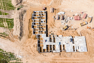 concrete foundation works during building construction. aerial view of city construction site