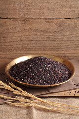 riceberry rice in golden tray on table with a blank space for a text, riceberry rice in kitchen background